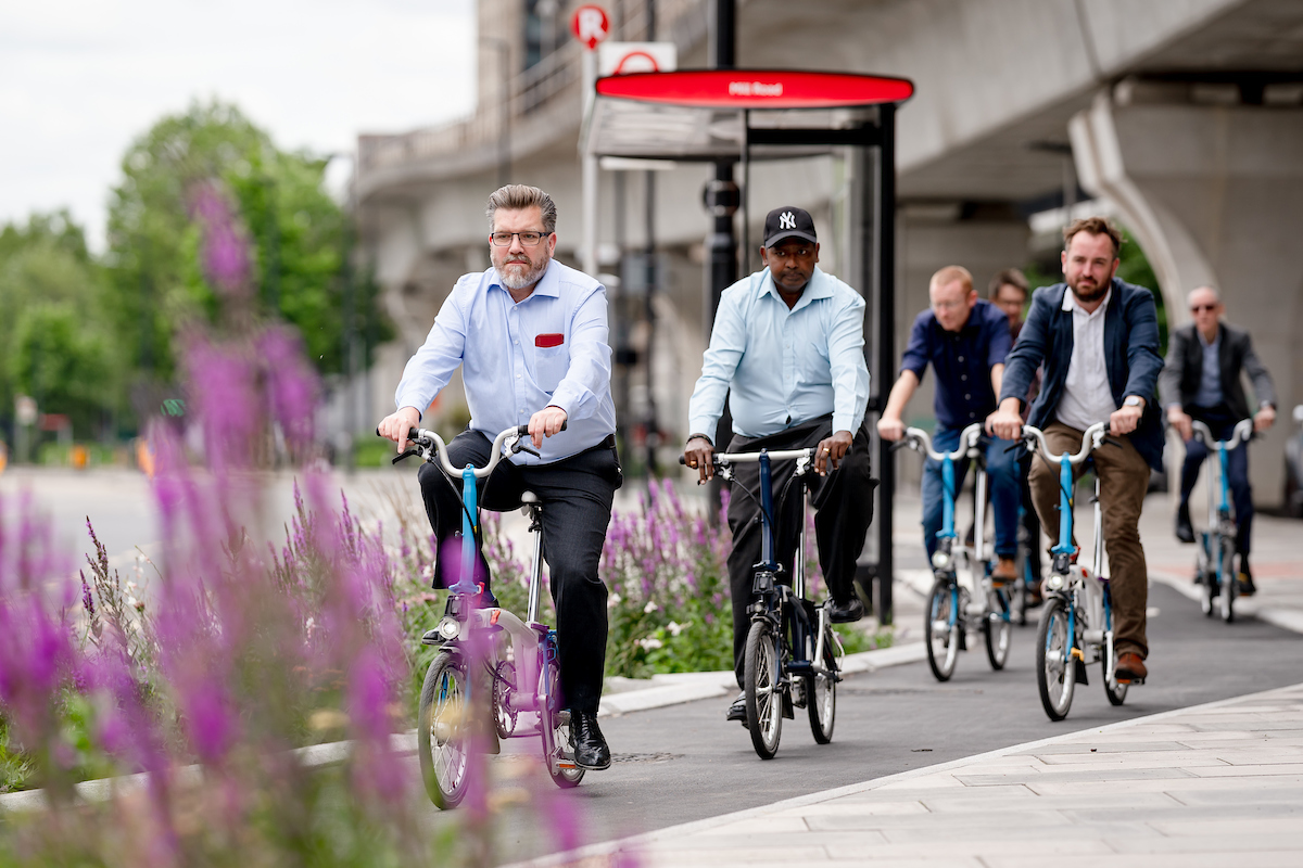 Deputy Mayor Cllr James Asser and the project team testing the new segregated cycle track with Brompton bikes