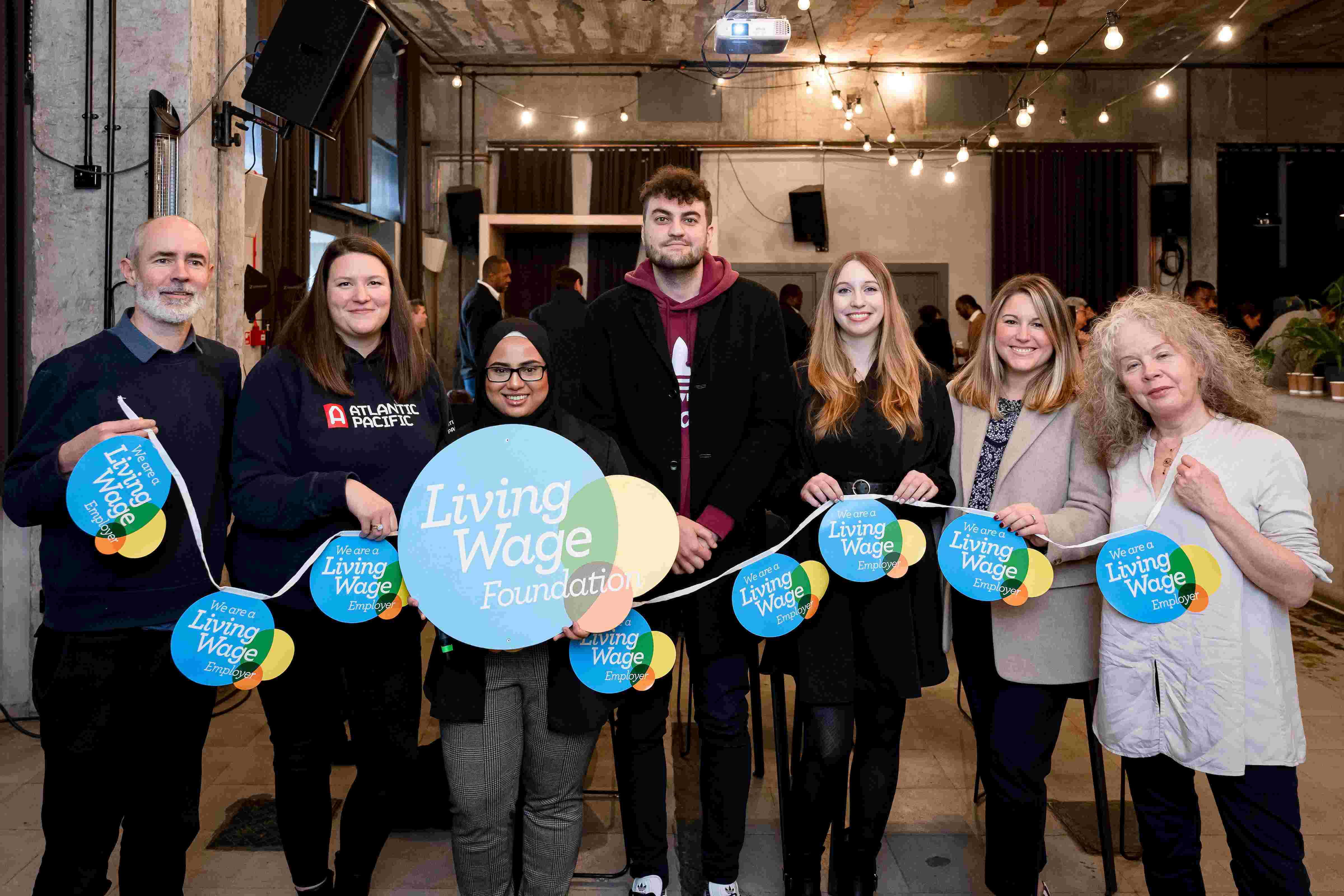 People holding London living wage banner at London living wage event