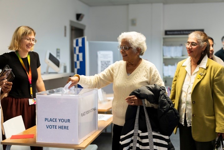 Residents submit their votes after hearing about local project proposals in their neighbourhood.